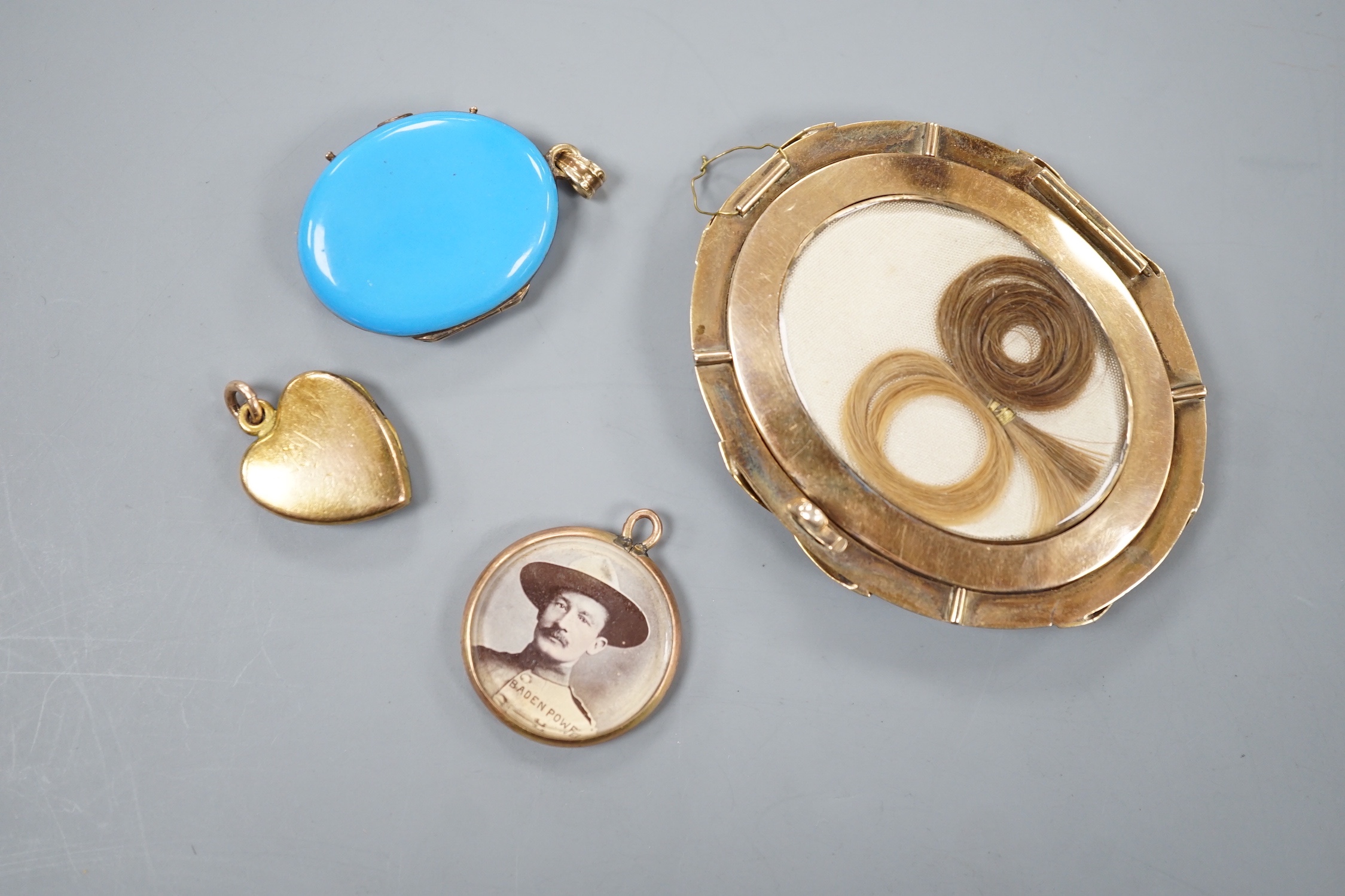A 19th century yellow metal miniature oval portrait mourning brooch, 54mm, two enamelled lockets(a.f.) and one other small pendant.